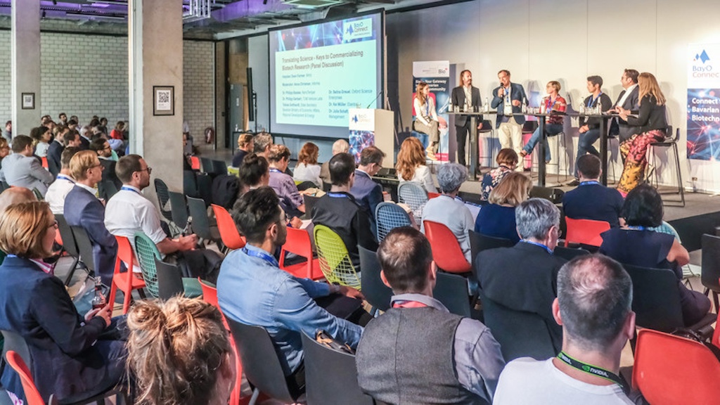 Philipp Baaske on a biotech panel, addressing the audience